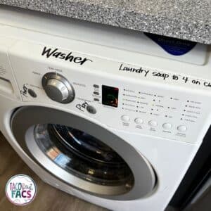 labeling the washer to makes sure students know the difference when doing laundry and the steps to start a washing load of towels.